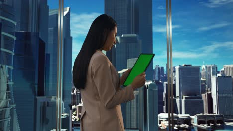 businesswoman using tablet in office with city view