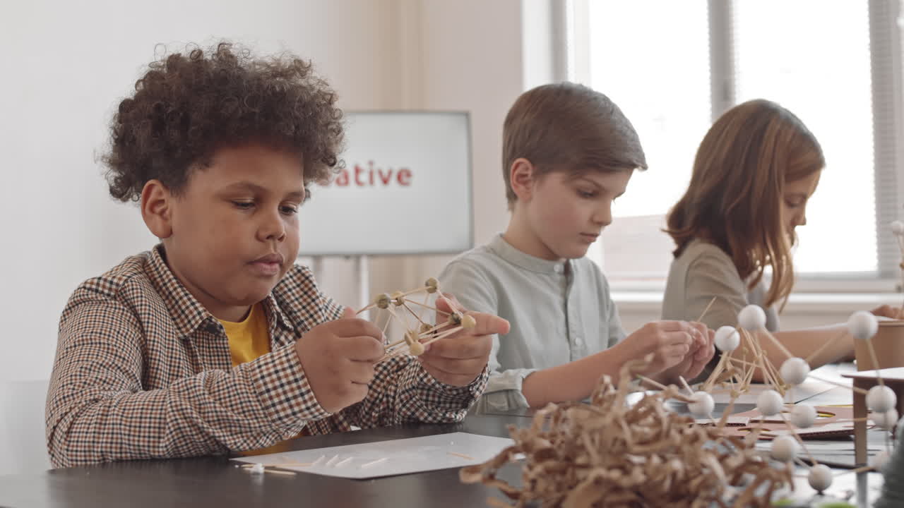 Biracial Boy Posing in Workshop Room