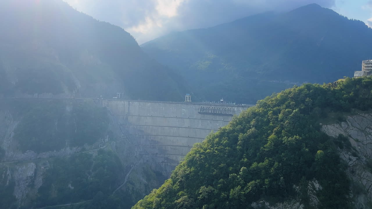 Static side view of dam in the middle of the mountains. Daylight. Mestia