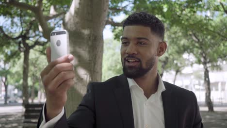 handsome bearded african american man having video call.