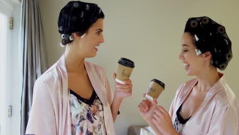 bridesmaids in nightdress and hair rollers toasting their coffee cups 4k 4k