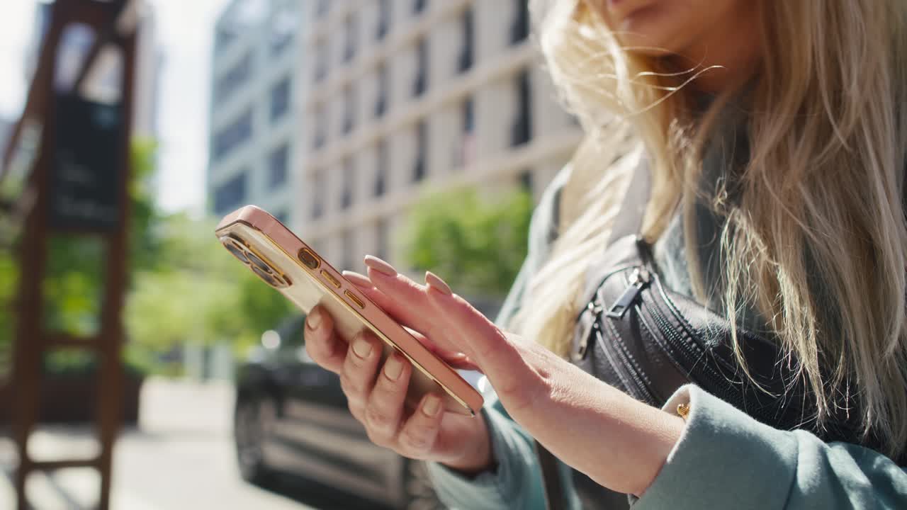 Unrecognizable woman browsing phone in the city