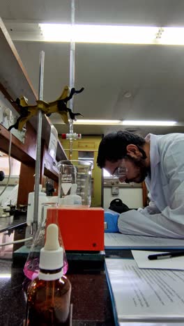 a man in a lab coat is working on a project