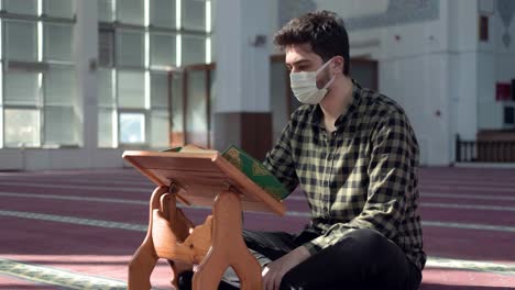 Masked-Muslim-Man-Reading-Islamic-Holy-Book