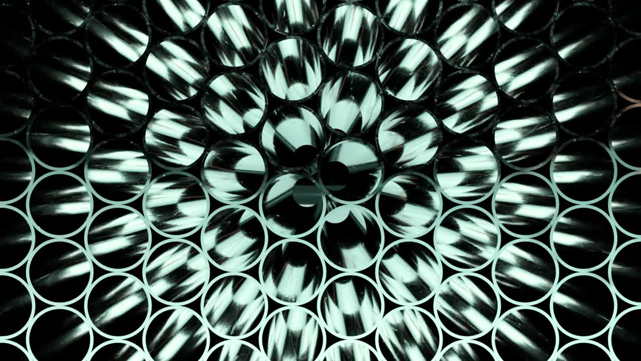 Rows of Metal Pipes with reflections and Sun Flares inside. Steel pipes at metal factory.