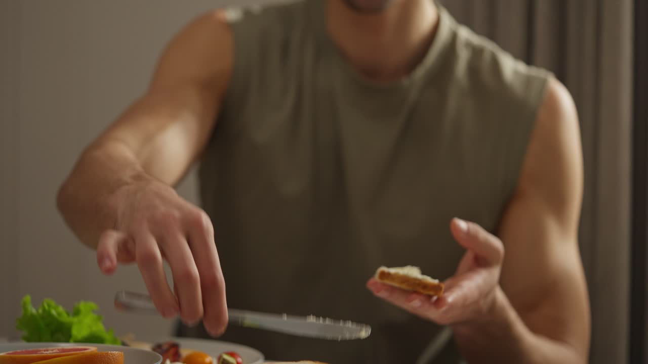 Man spreading butter on toast for breakfast