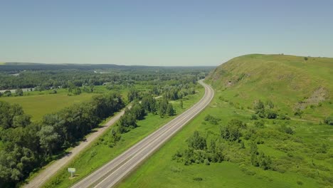 aerial flying over highway in the highlands view of the tourist city mountain river