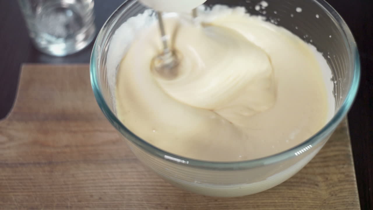 Mixing dough in bowl with motor mixer. Baking ingredients. Baking cake
