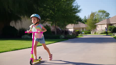 young girl riding a scooter outdoors