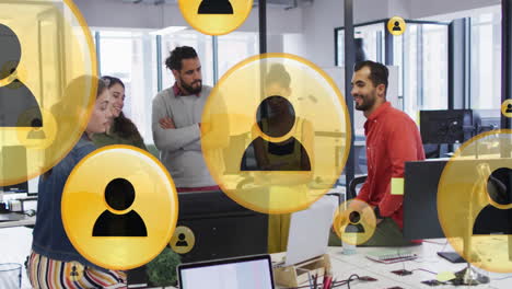 animation of media icons over happy diverse busines people discussing in office