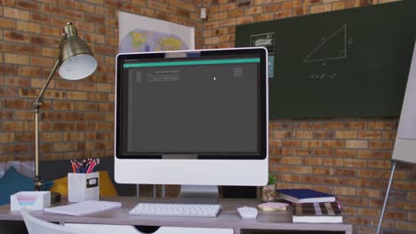 Computer screen with data processing standing on desk in office