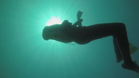 A-diver-dropping-his-camera-on-the-ocean-floor---underwater