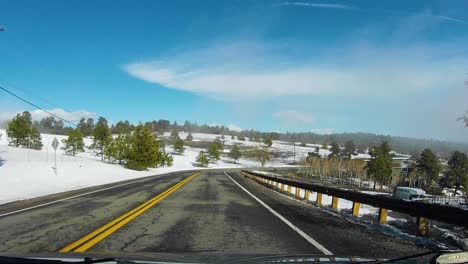 hyperlapse of driving on a mountain top road on a sunny day in late winter, time