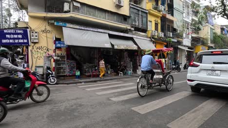 rickshaw driver navigating through busy urban traffic