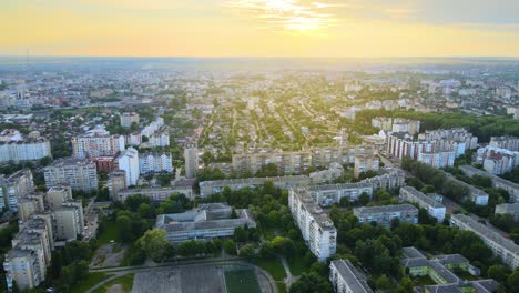 воздушный вид высотных многоквартирных зданий, частных домов и улиц в городском жилом районе вечером