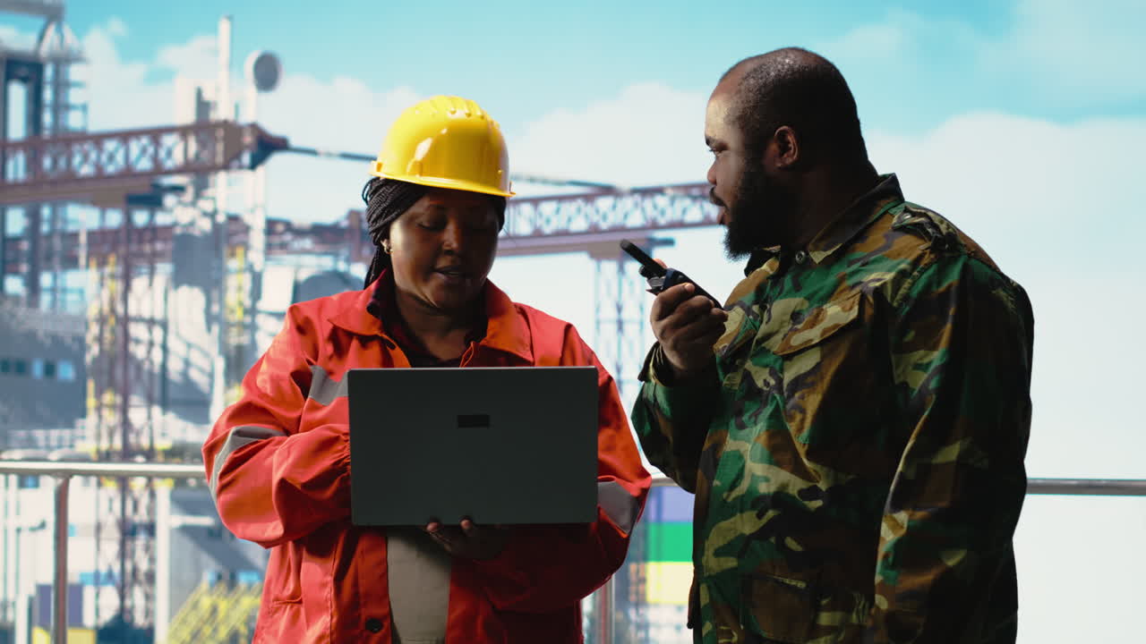 Vertical video Soldier on offshore platform transmitting security report with walkie talkie