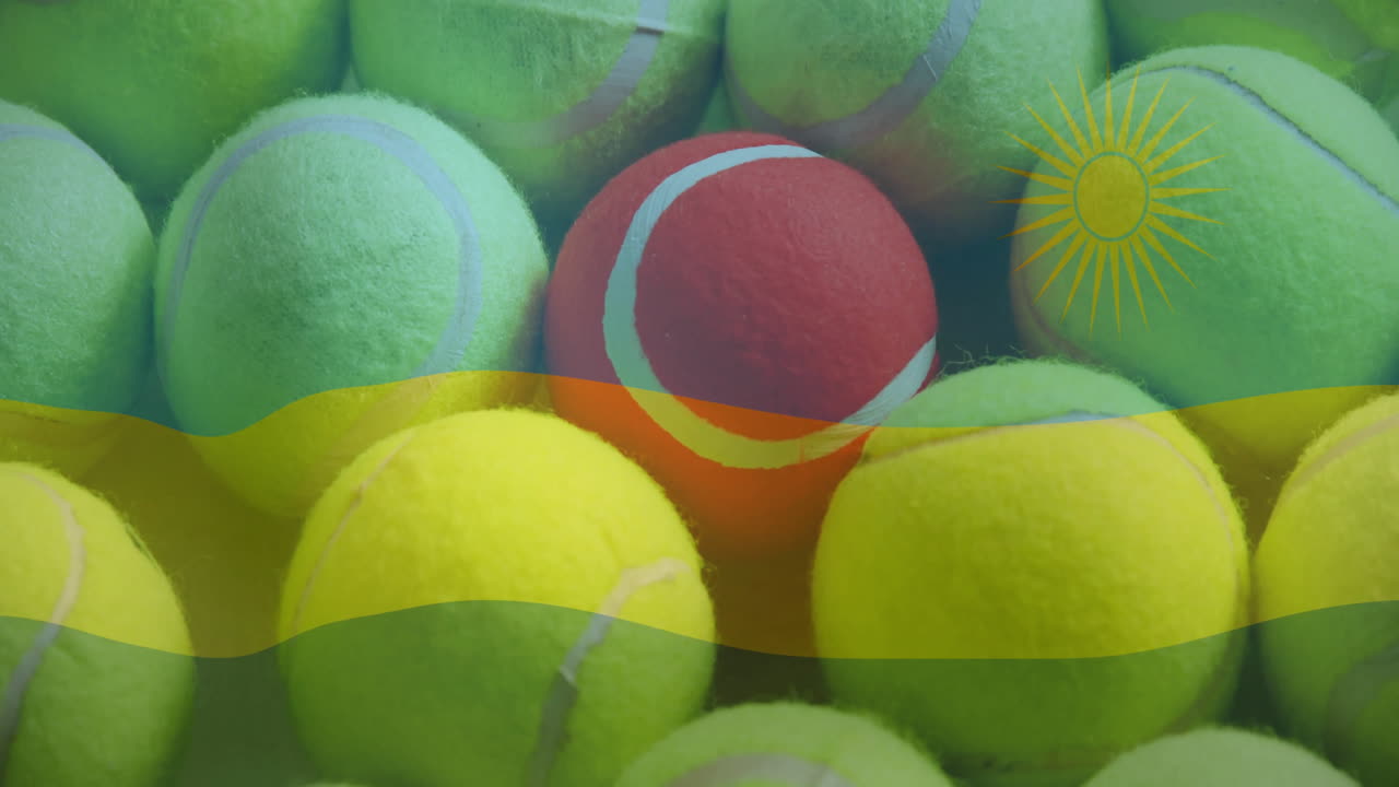 Tennis ball cluster being shown closeup, featuring central red ball under Rwanda flag stripes