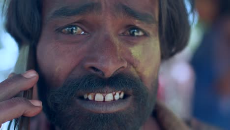 indian man close-up of face smeared with bright holi colors