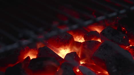 looking through the grill on burning embers of coal briquettes