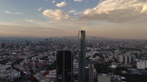 taking off over one of the tallest buildings in mexico city, drone view