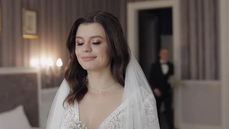 Newlyweds-young-caucasian-bride-and-groom-first-meeting-at-wedding-day,-making-a-kiss-indoors