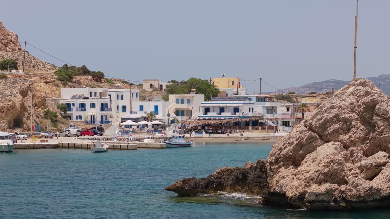 Aerial drone reveal of the traditional seafront of Finiki Village in Karpathos, Greece. Perfect for travel, tourism, lifestyle, and cultural projects