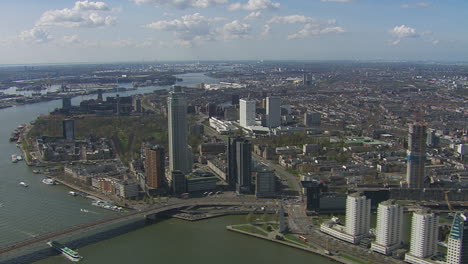 aerial establishing shot of downtown rotterdam during the day with multiple bridges