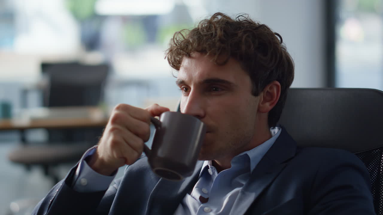 Smiling worker drinking coffee resting work break at panoramic cabinet portrait