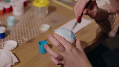 child painting an easter egg