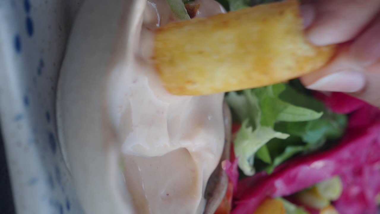 Dipping Fries in Sauce with Salad