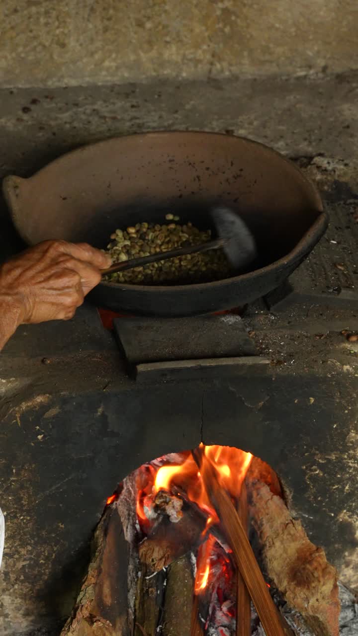 Kopi Luwak Coffee Roasting in Iron Pan over Flame. Slow Motion Vertical