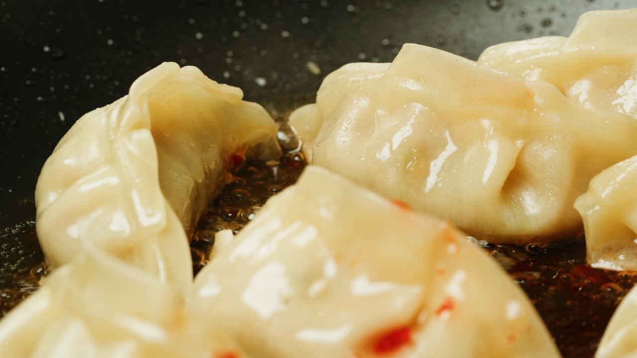 Close-up of Dumplings Frying in a Hot Pan