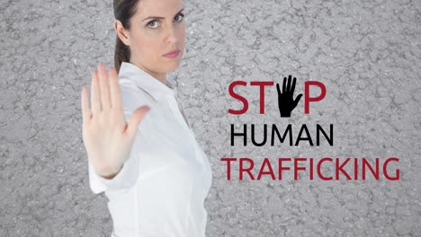 animation of stop human trafficking text over caucasian woman with stop gesture