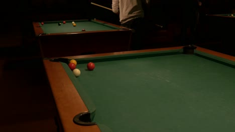 shooting yellow ball into pool table pocket and rolling up and down table