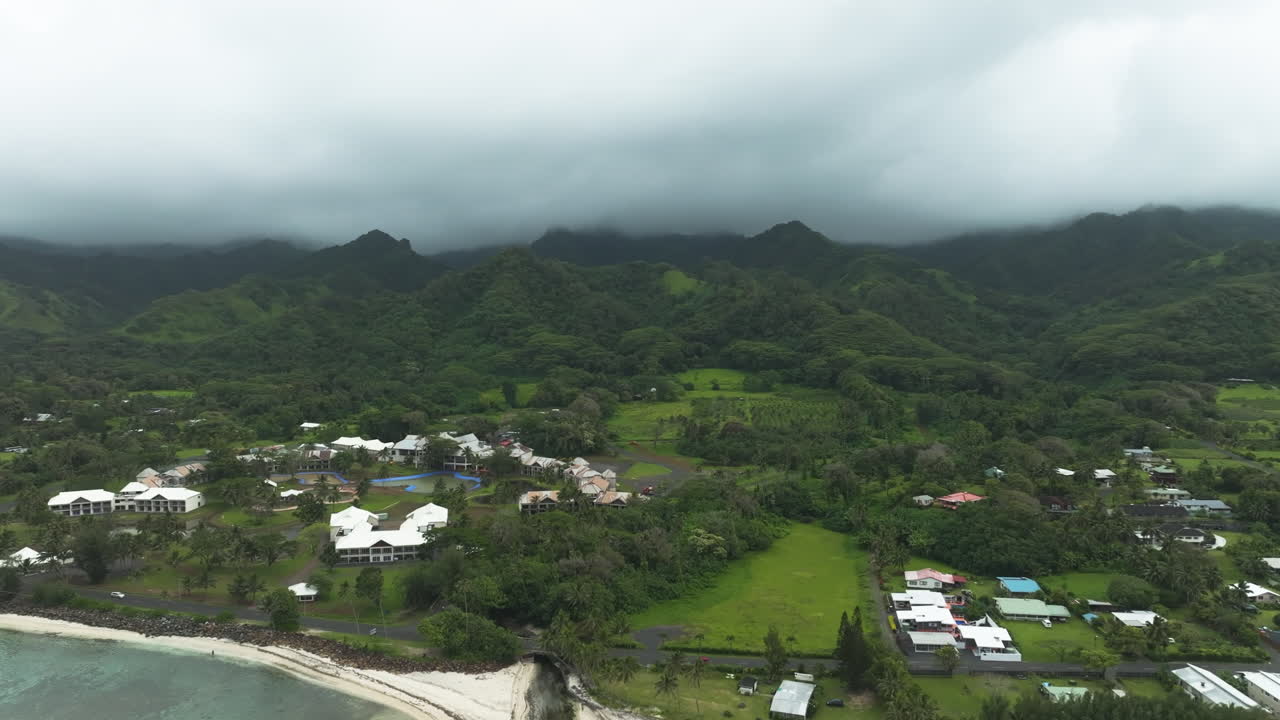 Aerial establishing of abandoned hotel in Rarotonga Cook Islands, overcast day