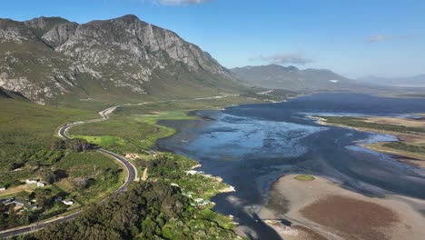 elevated aerial view over klein river lagoon next to scenic mountains, hermanus