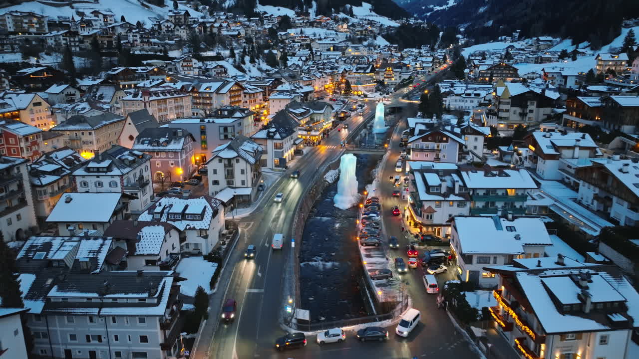 Aerial drone view of the Ortisei town covered in snow, within the Dolomites, in northern Italy
