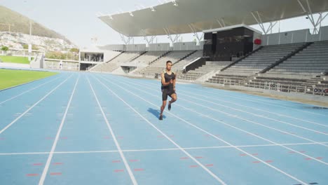 Mixed-race-athlete-running-in-stadium