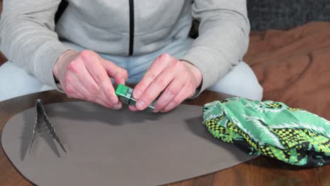 a man prepares cannabis marijuana seeds from a box for planting and growing, static shot, medium close up