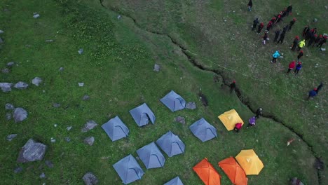 camping site near a crevice in the mountains in sar pass - aerial shot