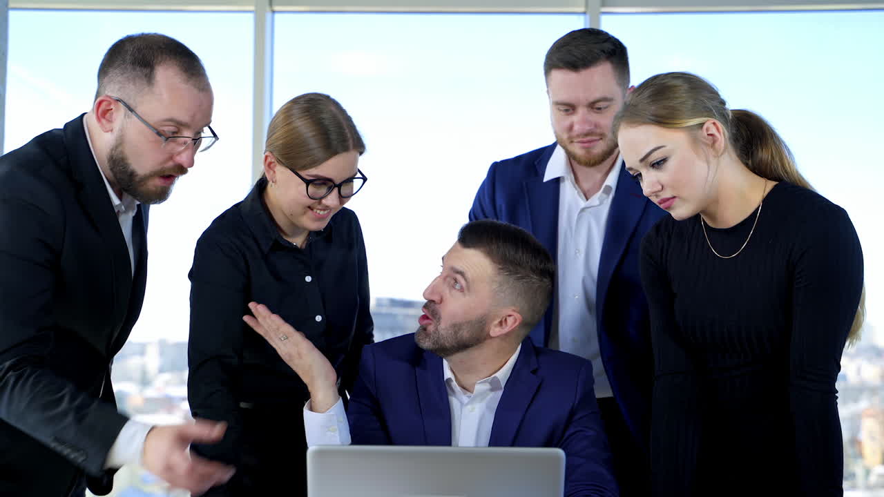 Brainstorming of young business people. Group of young business partners collaborating together using a laptop in office room.