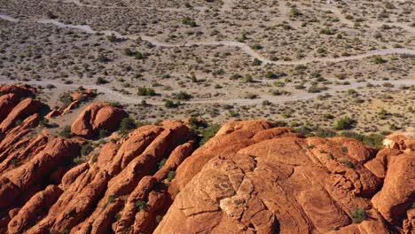 aerial view overlooking details of erosion on red sandstone cliffs in sunny usa - pan, drone shot