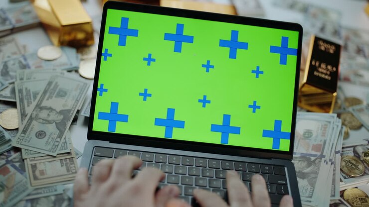 Laptop med penge og guld