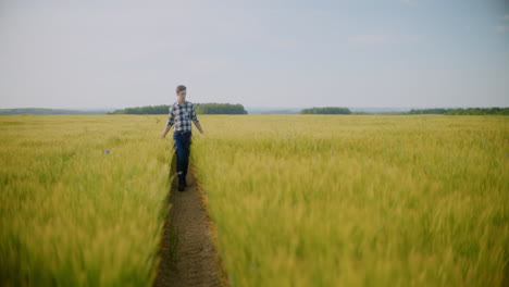 farmer walking through wheat field