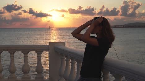 woman watching sunset at the seaside balcony