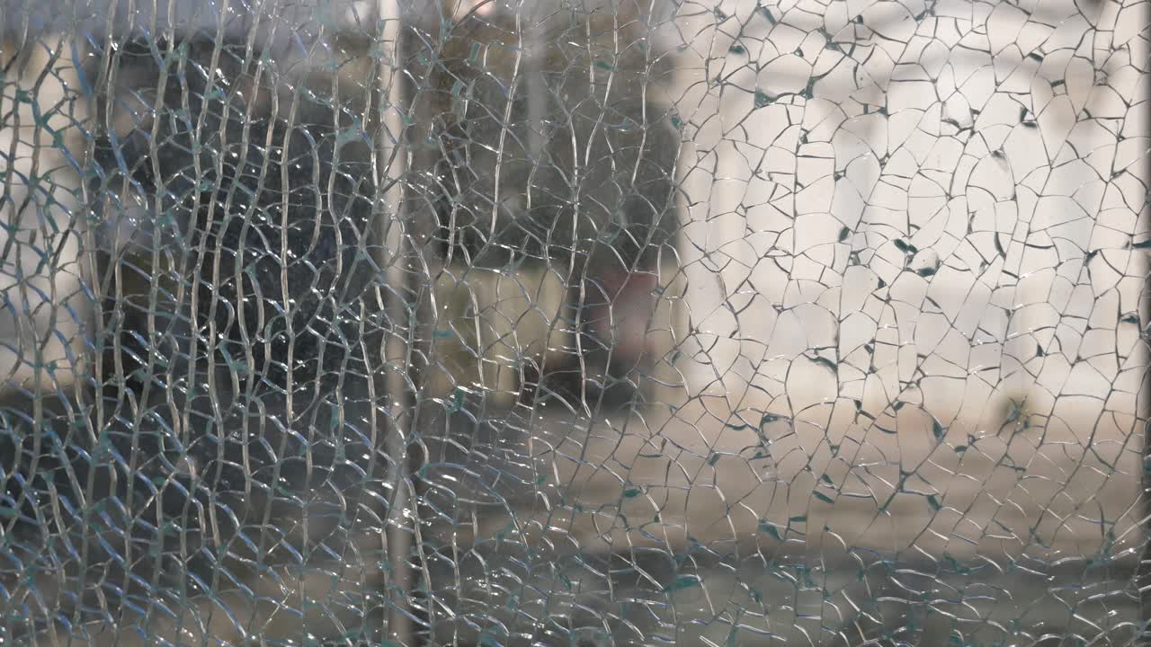 Broken Window with People in the Background