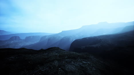 dark-atmospheric-landscape-with-high-black-mountain-top-in-fog