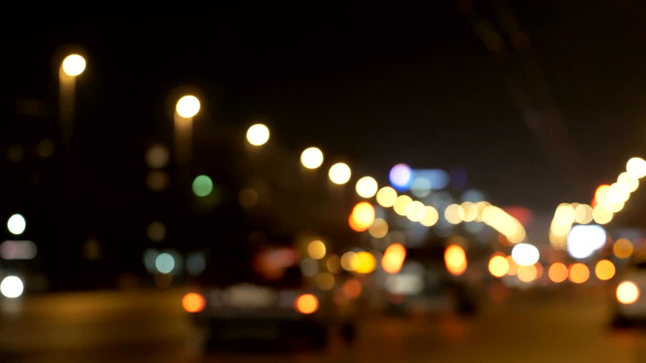 luces desenfocadas calle de los ángeles resumen. fondo borroso de la ciudad. círculos de bokeh en movimiento del tráfico nocturno.
