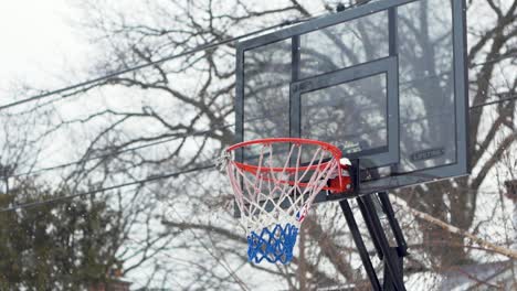 lonely basketball hoop waiting in the snow