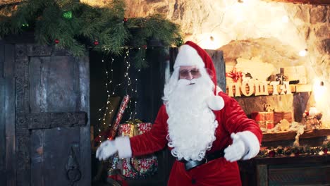 santa claus in his residence bows and invites you to enter the interior